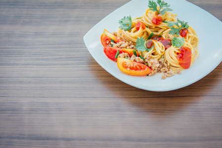 spaghetti with tomato sauce on wood backgroundの写真素材