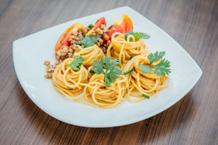 spaghetti with tomato sauce on wood backgroundの写真素材