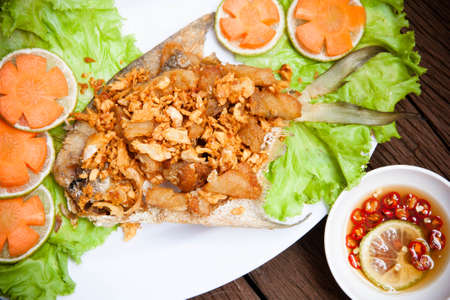 Fried fish fillet with garlicの写真素材