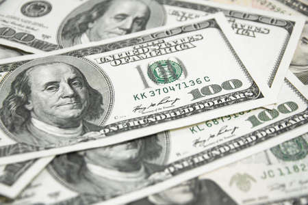 One hundred dollars on wood background