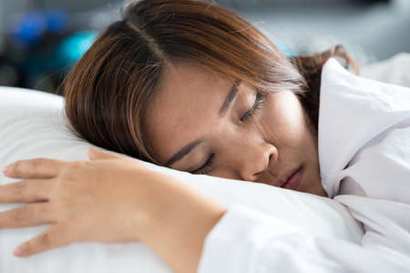Asian woman sleeping on bedの写真素材
