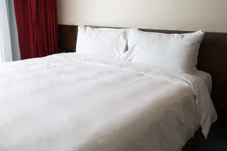 White bed sheets and pillowsの写真素材