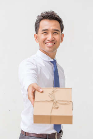 Businessman offering a giftの写真素材