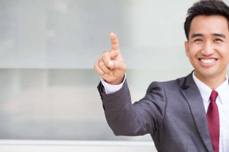 Business Man pushing on a touch screenの写真素材