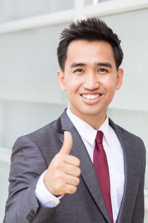 Asian businessman showing thumb upの写真素材