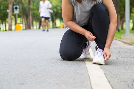 Woman tying shoe lacesの写真素材