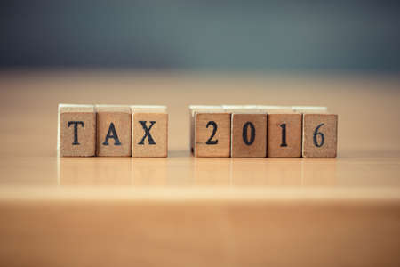 Tax 2016. word written on wood block, vintage retro color tone