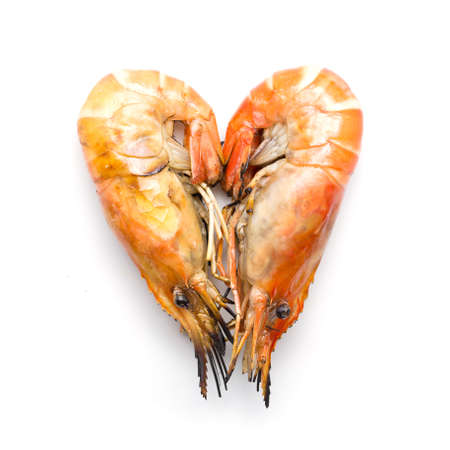 Grilled prawn were arranged heart shape on white backgroundの写真素材