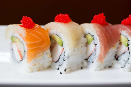 Sushi set, sushi roll with salmon and sushi roll with avocado.