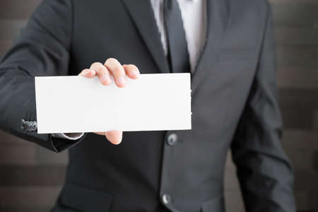 Businessman showing blank signboard