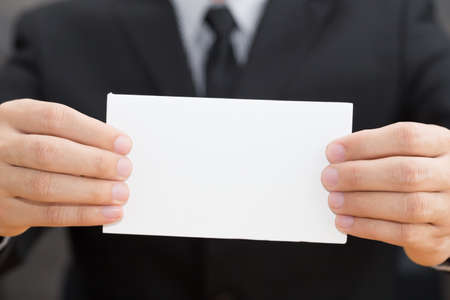 Hand of businessman showing white paper