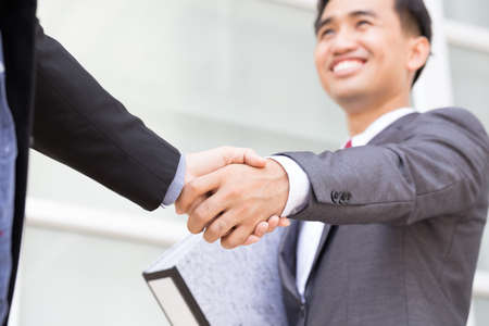 Asian businessman making handshakeの写真素材