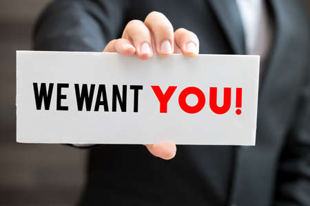 We want you, message on blackboard and hold by businessmanの写真素材