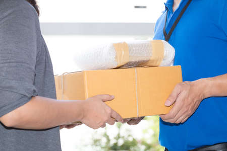 Woman hand accepting a delivery of boxes from deliveryman