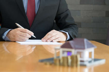Businessman signing a contract for real estate investingの写真素材