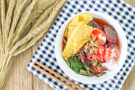 Noodles with seafood soup and red sauceの写真素材