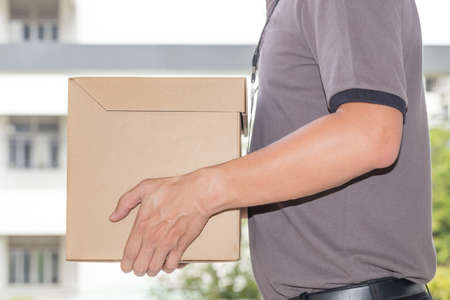 Delivery man holding a parcel box. Delivery service conceptの写真素材