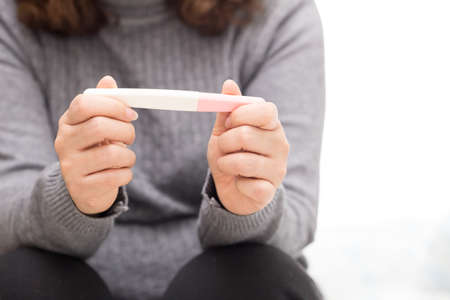Woman holding pregnancy test, New life and new family concept.