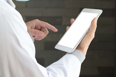 Male doctor hands holding tablet pcの写真素材