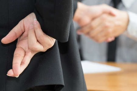 Dishonesty, Business fraud concept, Businessman showing fingers crossed