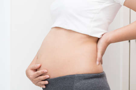 Pregnant woman with backacheの写真素材