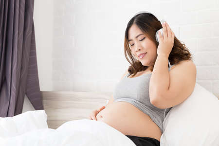 Pregnant woman listening to musicの写真素材