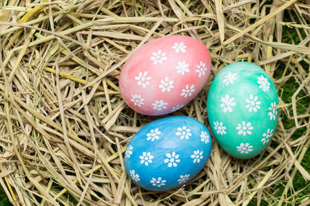 Easter eggs on straw backgroundの写真素材