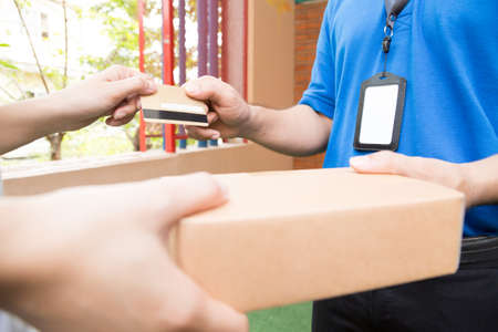 Customer paying by credit card for shipping product and sending to shipping manの写真素材