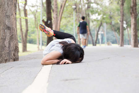 Accident. stumble and fall while running in parkの写真素材