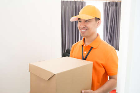 Delivery man shipping the box to clientの写真素材