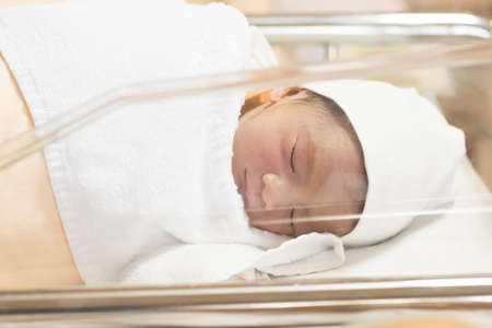 Newborn baby boy sleep at obstetric room in hospital, 1 days of life, Asian baby