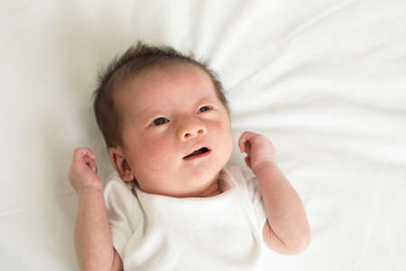 Asian baby boy smiling and imaginingの写真素材