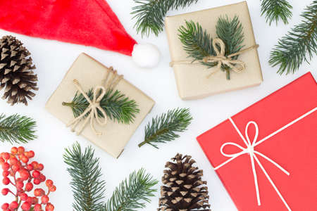 Top view of Christmas composition, gift box, pine cones, fir branches on white background