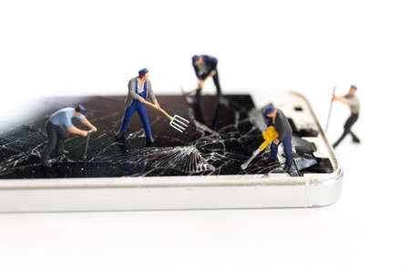 Mini technicians repairing broken screen phones caused by falling, Smartphone hitting the street and...