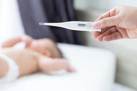 Measure the body temperature of the baby with digital thermometer, Infants may have a fever conceptの写真素材