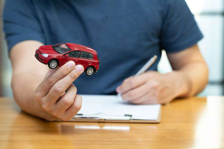 Men are choosing to buy and sign contracts policy with vehicle and car insurance, Protection of car conceptの写真素材