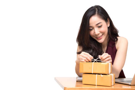 Asian women packing parcel on the table and white background, Female receive cardboard box from...