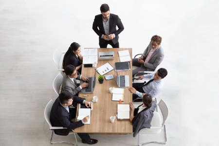 Top view of group of multiethnic busy people working in an office, Aerial view with businessman and...