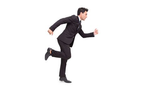 Handsome Caucasian businessman in formal suit is running isolated over white backgroundの写真素材