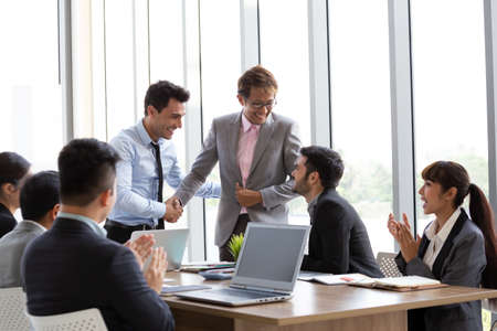 Handshake between the foreign CEO and the Asian manager who can successfully complete the project...