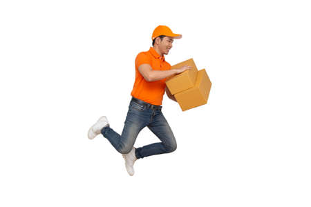 Energetic young Asian delivery man jumping and holding boxes isolated on white background, Deliveryman with parcel post box and fast shipping conceptの写真素材