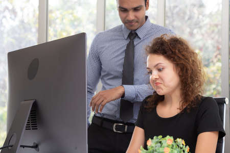 Unhappy secretary worker bored with annoying boss complaining about daily report summaryの写真素材