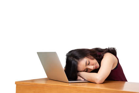Very tired business Asian woman fell asleep on laptop computer