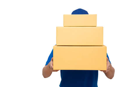 Delivery man courier holding parcel box package isolated on white background. Deliver and shipment conceptの写真素材
