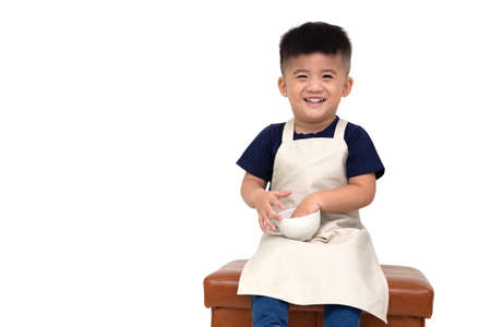 Happy Asian barista boy smiling and holding coffee cup isolated on white backgroundの写真素材