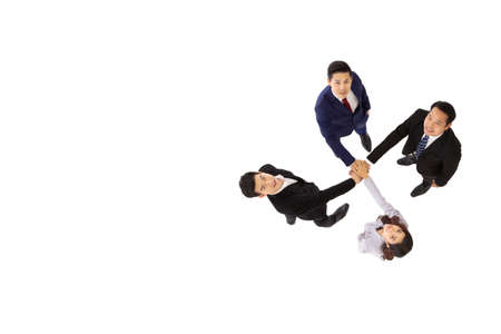 Asian businessmen and businesswomen joining hands in group meeting isolated on white background,...