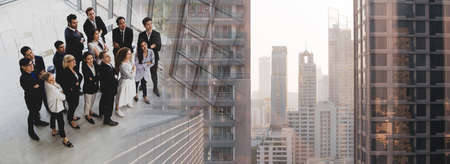 Multiracial business people standing together with arms crossed for successful organization team. Celebrated, Business leadership, teamwork power and confidence concept. Double Exposure styleの写真素材