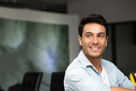 Handsome man smiling in the office, Feeling positive concept