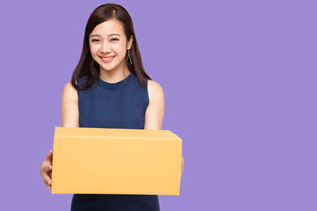 Happy Asian woman holding package parcel box, Delivery courier and shipping service concept