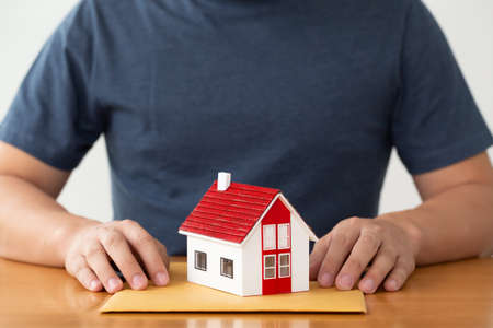 Man preparing documents file for loan home and refinance